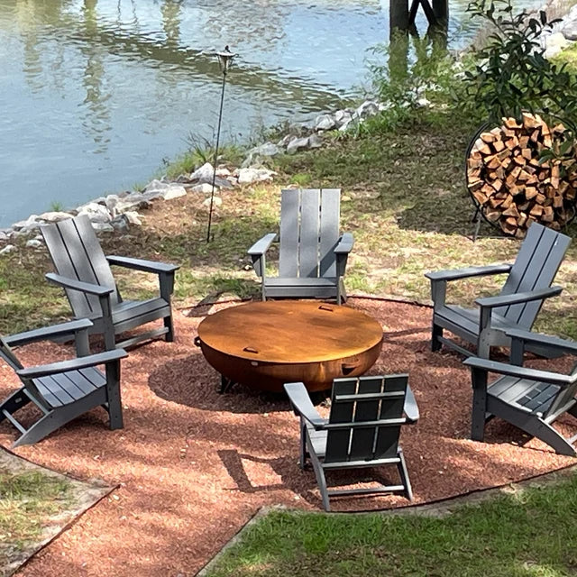 48 Inch Steel - Heavy Duty Outdoor Backyard Patio Fire Pit by lake in the forest and possibly close to a mountain